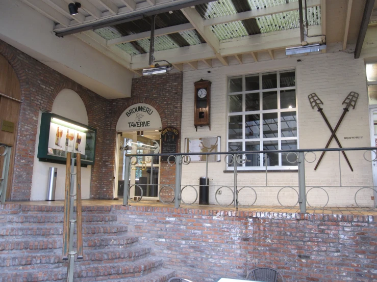 a brick building with a sign in front and outside