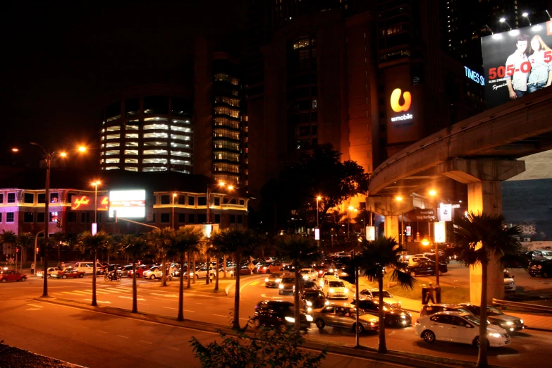 a city street filled with traffic next to tall buildings