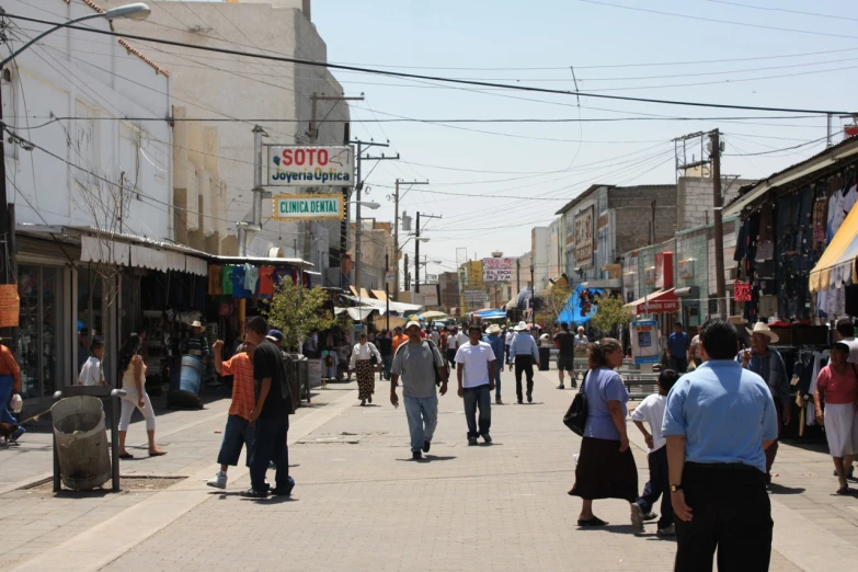 people walk through an old - fashioned market district