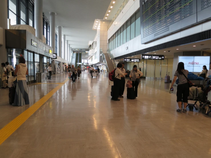 people standing around the entrance to an airport