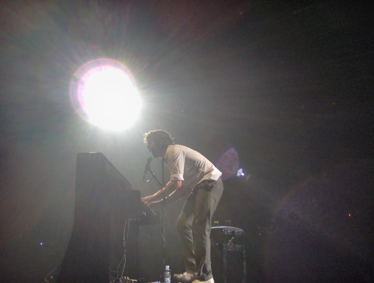 a person standing on top of a stage in front of a microphone