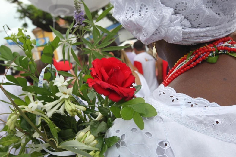 there is a female in a white dress and flowers