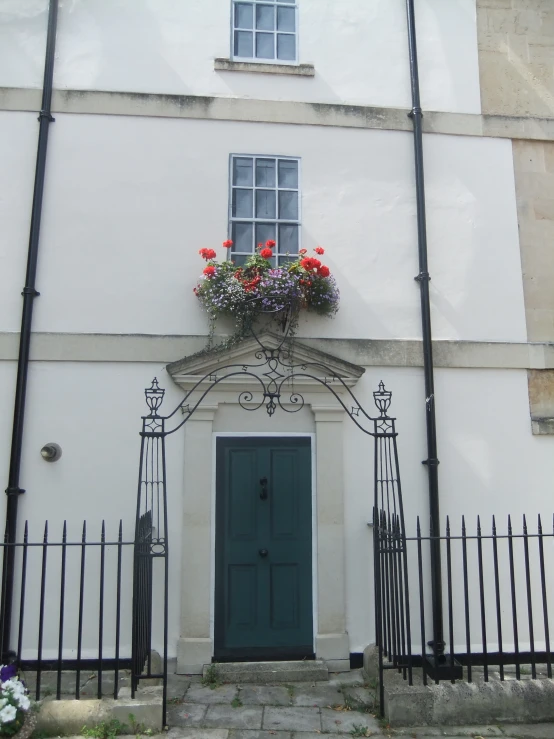 a white building with flowers hanging from the windows