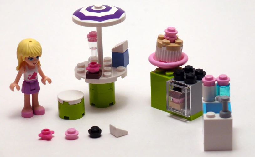 lego girls are creating a toy kitchen in a white background