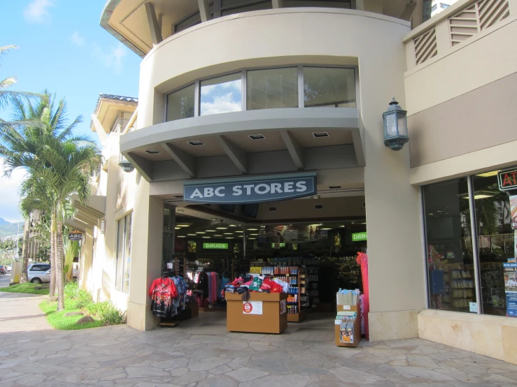 the entrance to an abc stores building with a lot of merchandise in the front