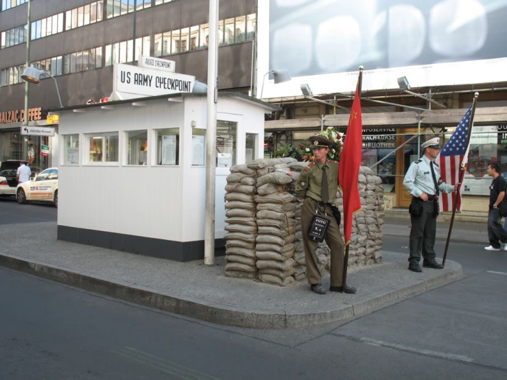 an officer is standing by piles of sand bags