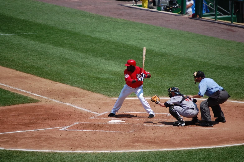 an umpire, catcher and batter on a baseball field