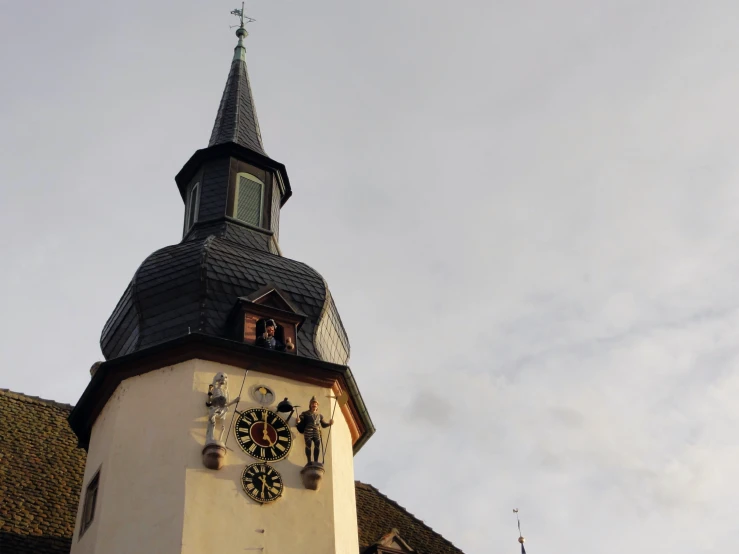 the bell tower on the church has multiple clocks on it