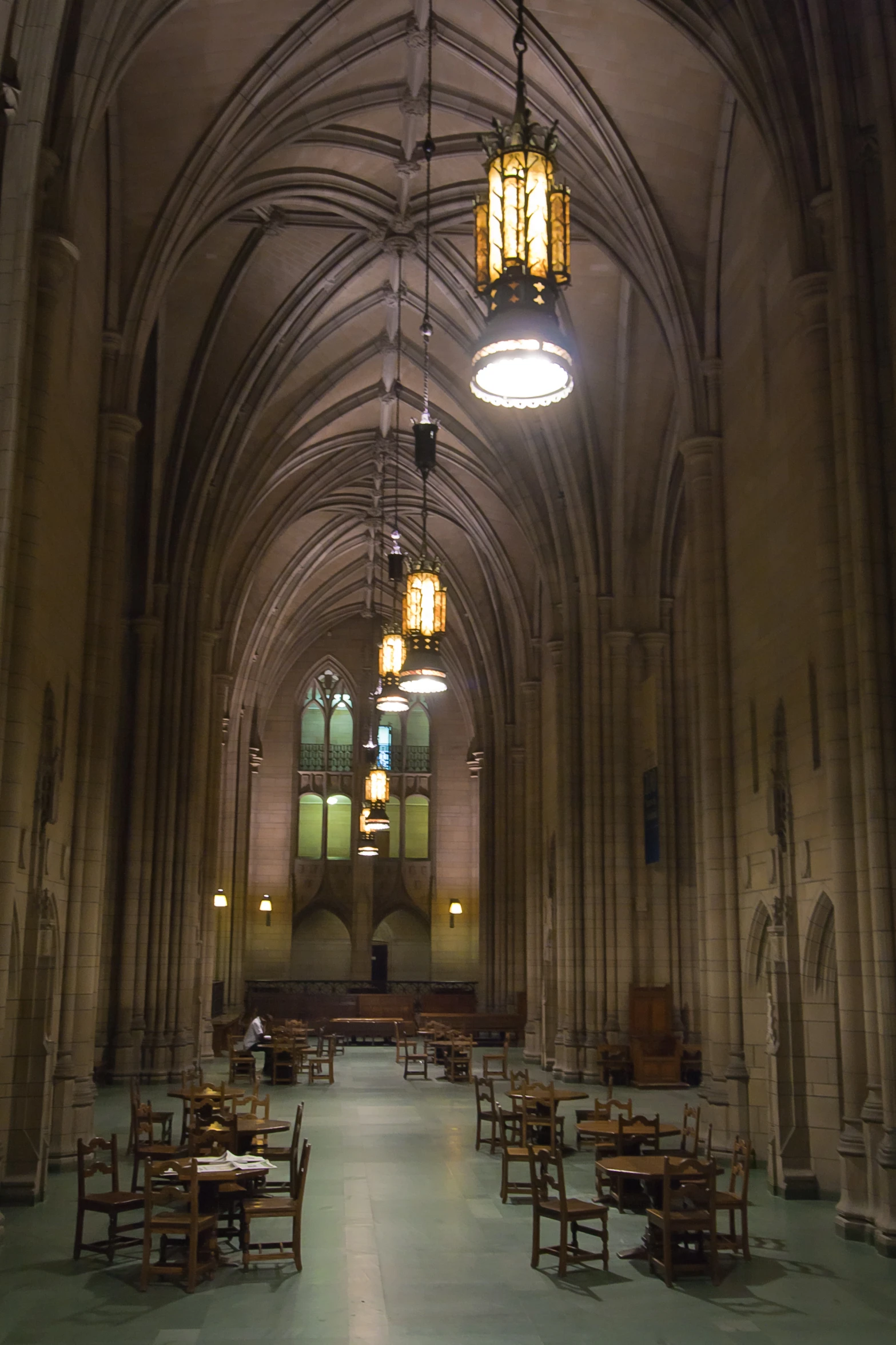 dining room with tables and chairs in a cathedral like building