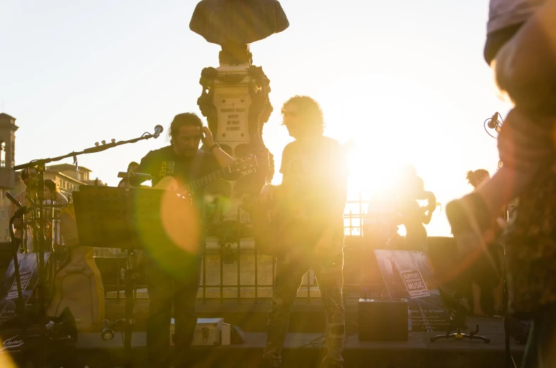 a band performs on stage in the sun