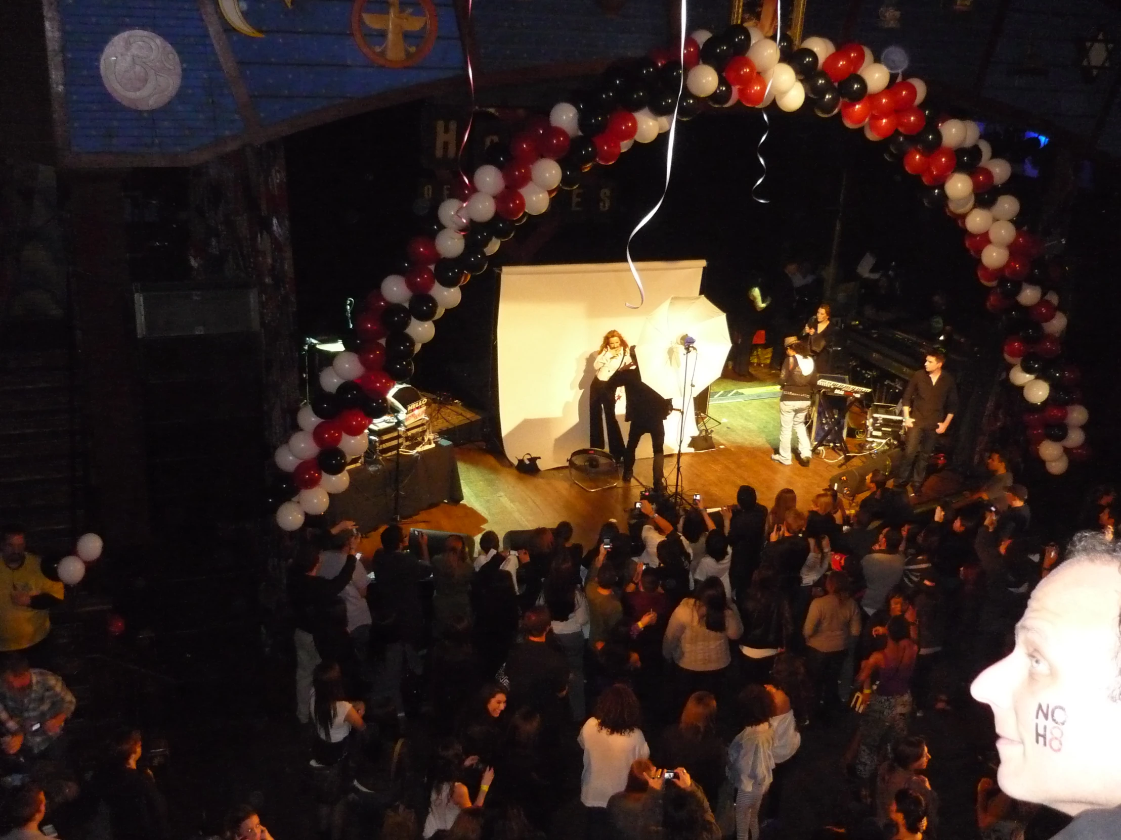 a view from a balcony shows a large band performing in front of a crowd