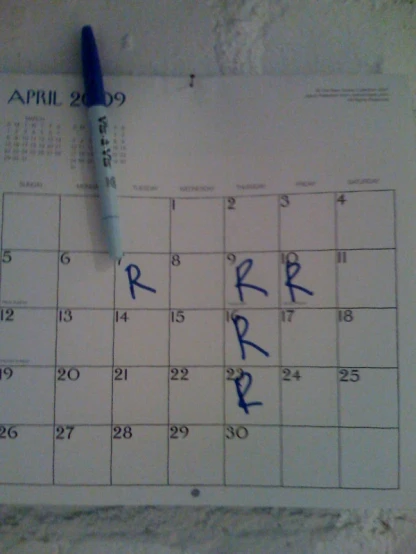a pen is on top of a calendar