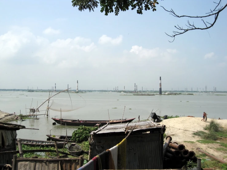 several ships parked near the water and an overpass