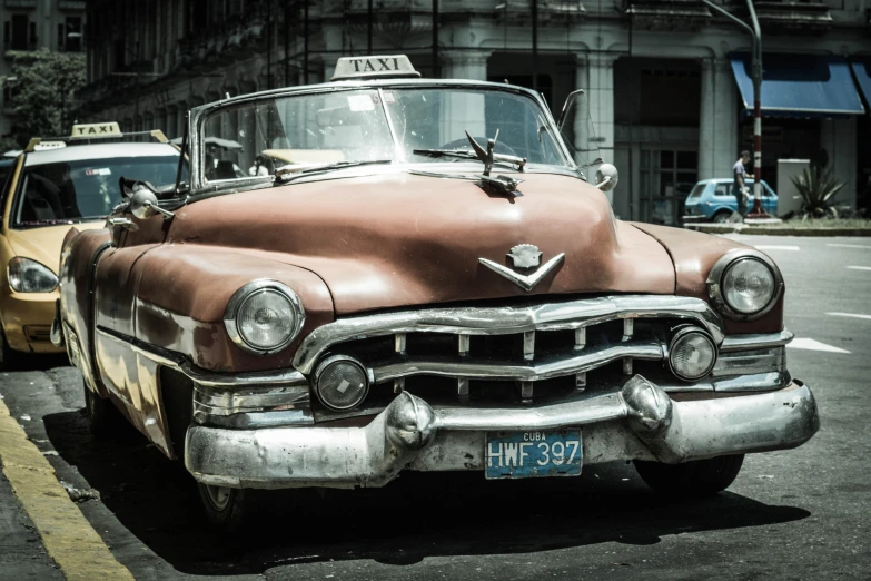 an old - fashioned vintage taxi parked on the curb