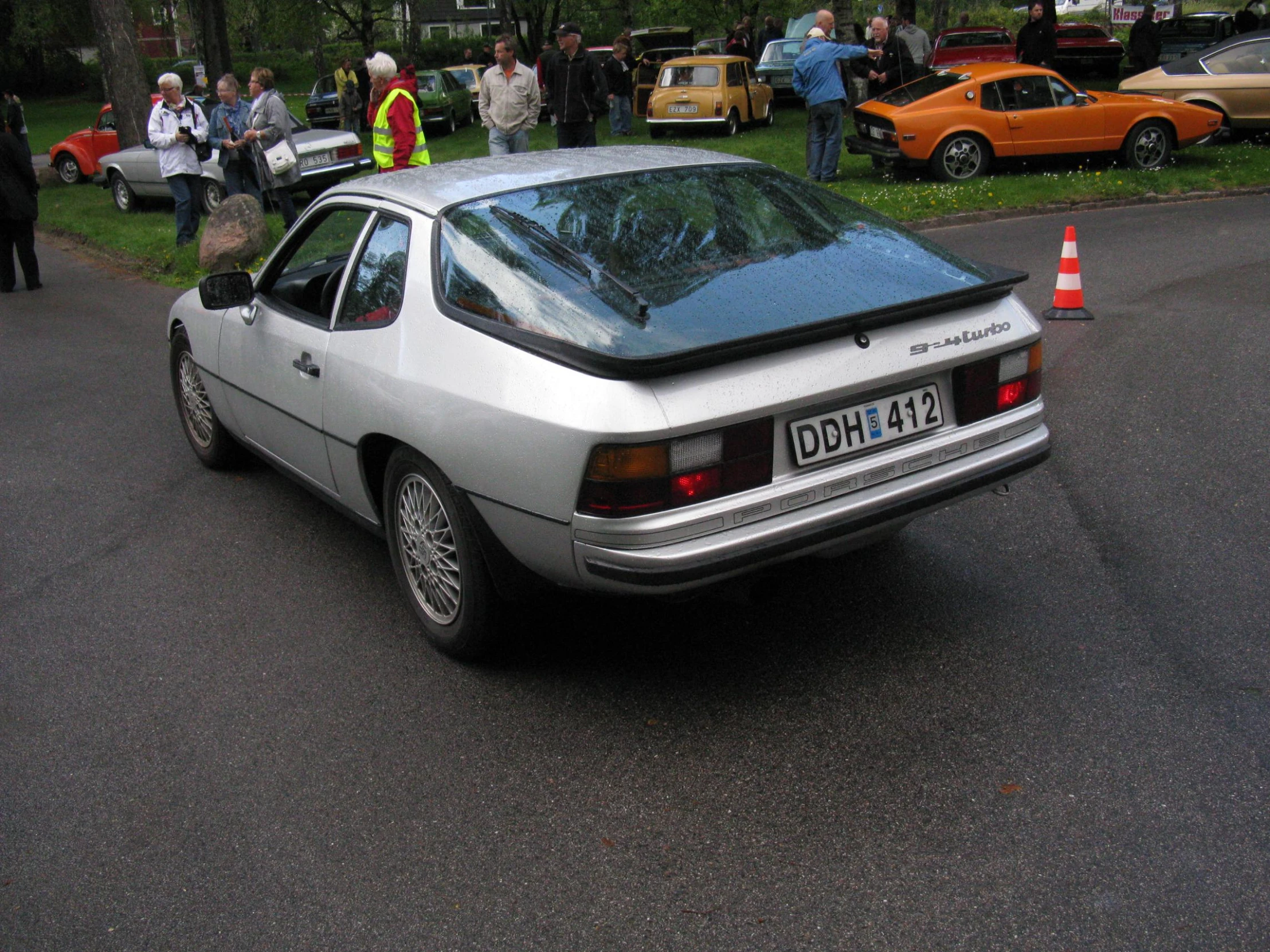 a grey car parked by the side of the road