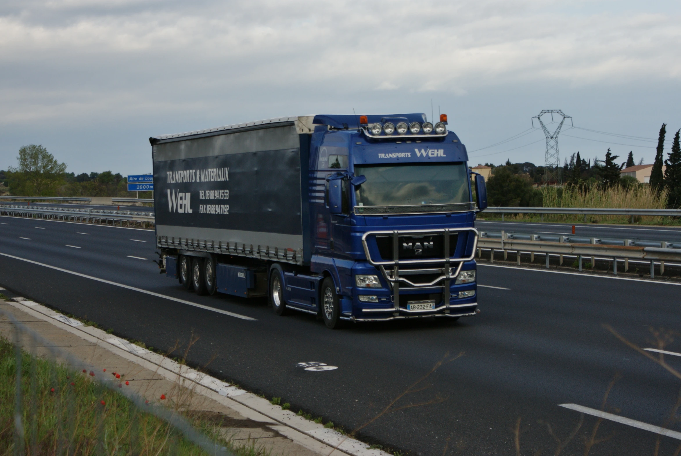 a large truck on a highway going through town