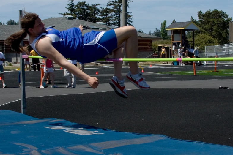 the young man is practicing his high jump ss