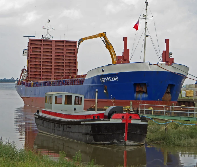 a boat sits in the water next to a building