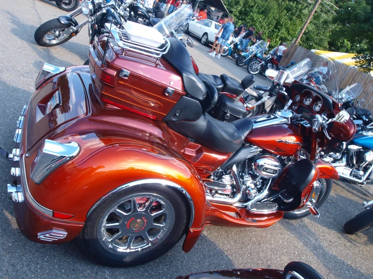 an orange motorcycle parked on the side of a road