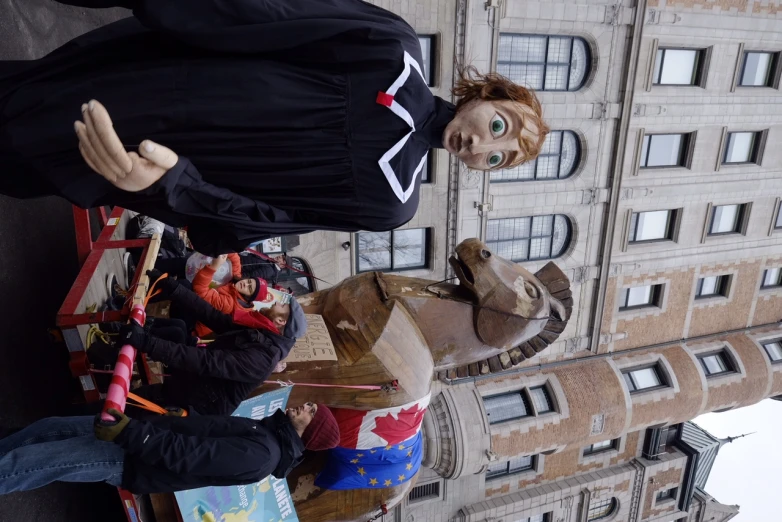 a fake person in a graduation gown next to a float