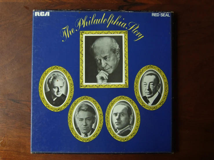 a picture of a blue album with four pictures of men