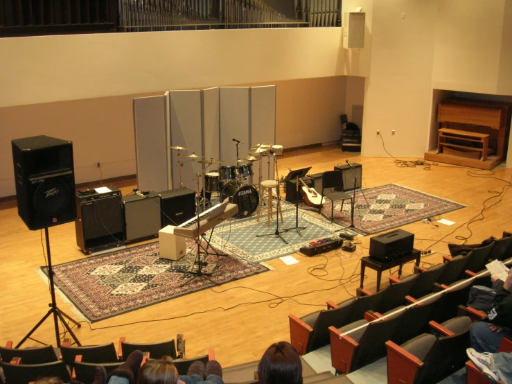 several acoustic instruments and amps are on the stage