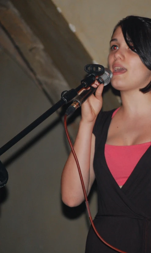 a woman standing in front of a microphone