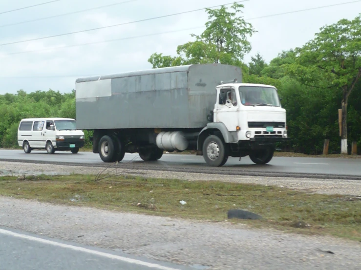 a truck and car driving down the highway