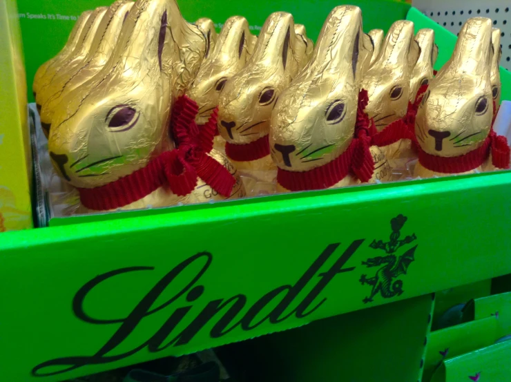 some chocolate bunny shaped eggs are lined up for sale