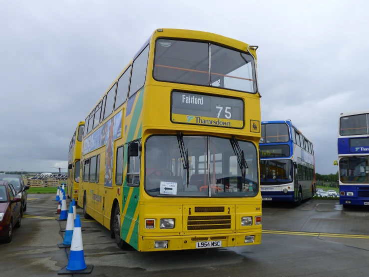 double decker buses parked in a lot during the day