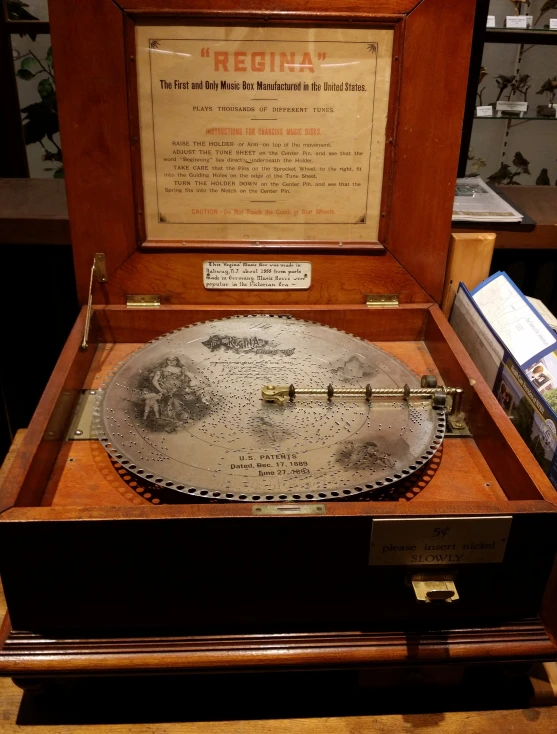 a large metal plate inside of a wooden case