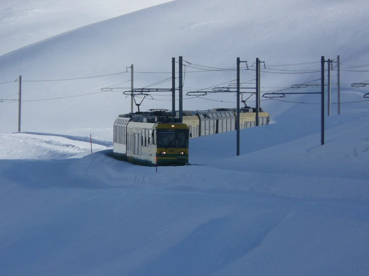 the train is traveling down the tracks through the snow