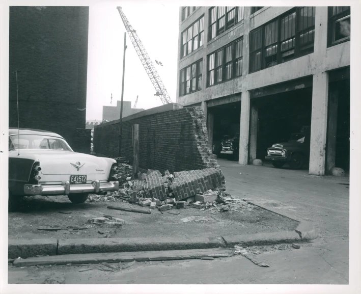 there is a old picture with a pile of items on the side of a road