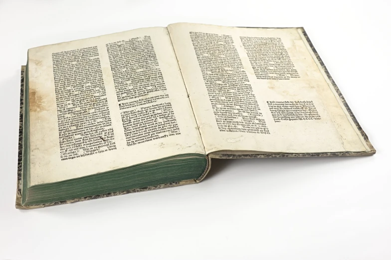 an old book is open with many letters on it