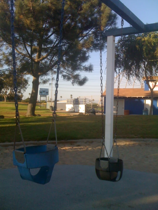 an empty swing set hanging on the side of a building