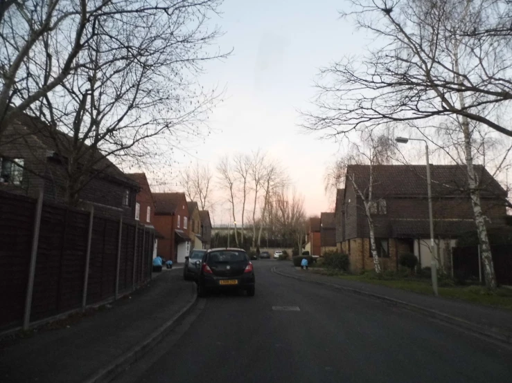 a car driving down the street in a residential area