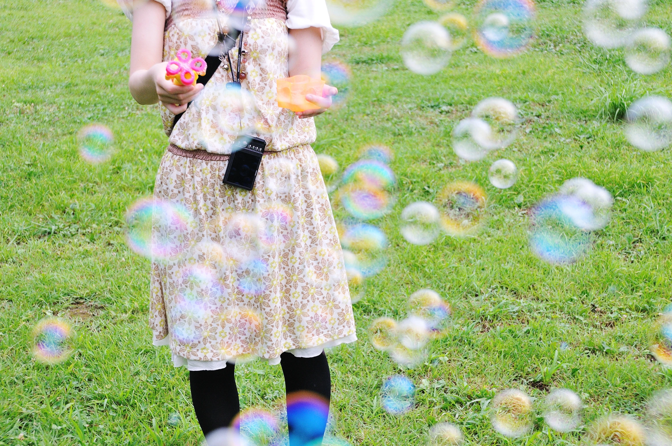 a  standing in front of soap bubbles
