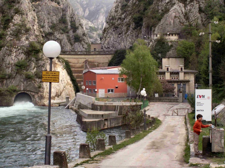 a small bridge crosses the river next to a town