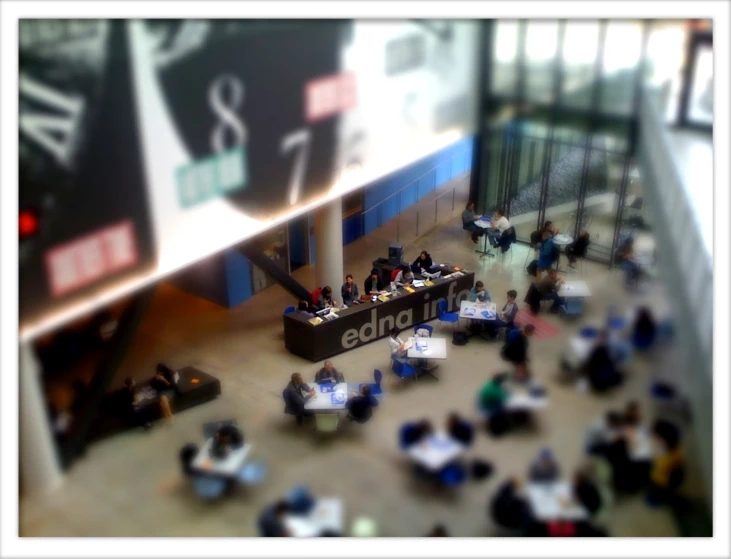 an overhead view of people at a counter in a lobby