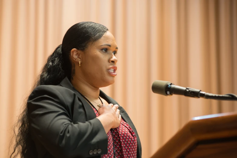 a woman standing at a podium giving a speech