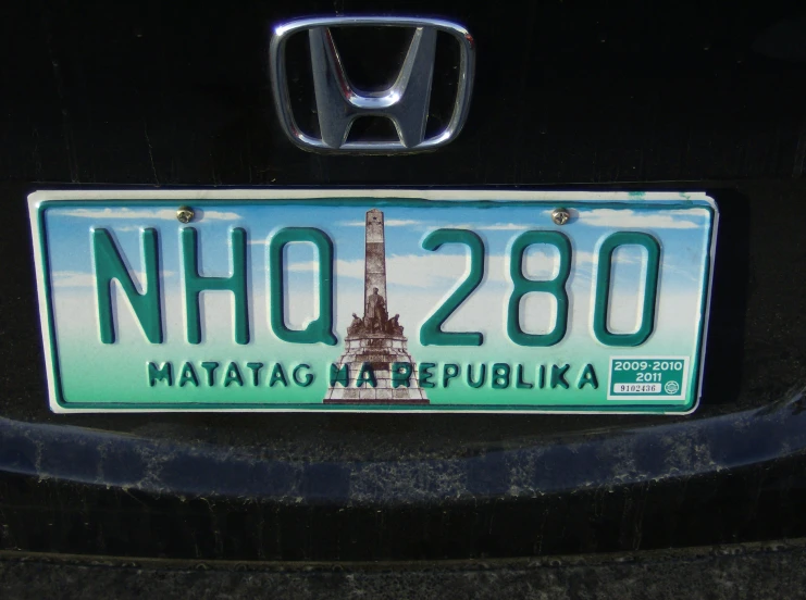 a license plate with the eiffel tower and a blue sky in the background