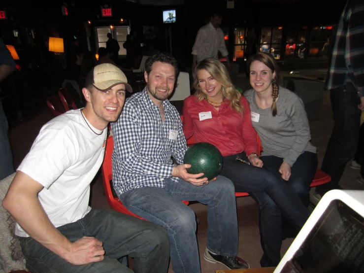 a couple with three women and two men smiling