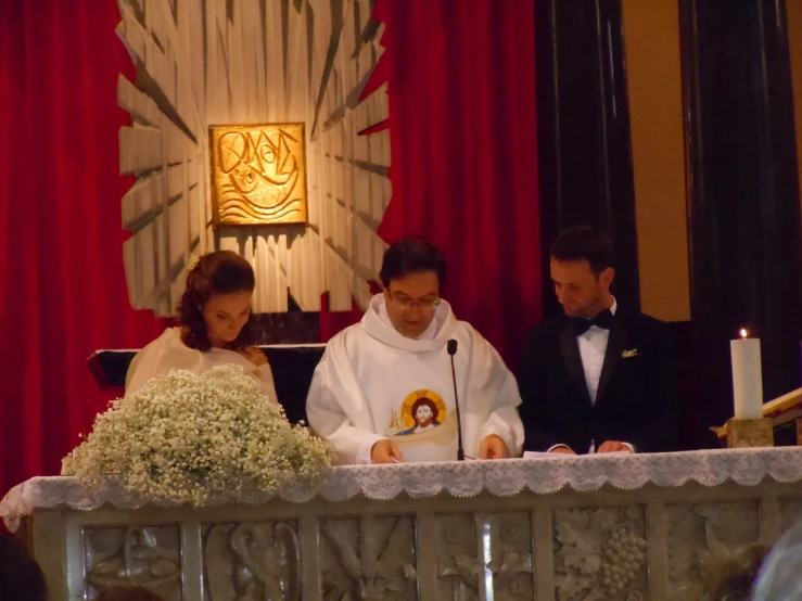 a couple dressed in catholic clothing look over their celetorys