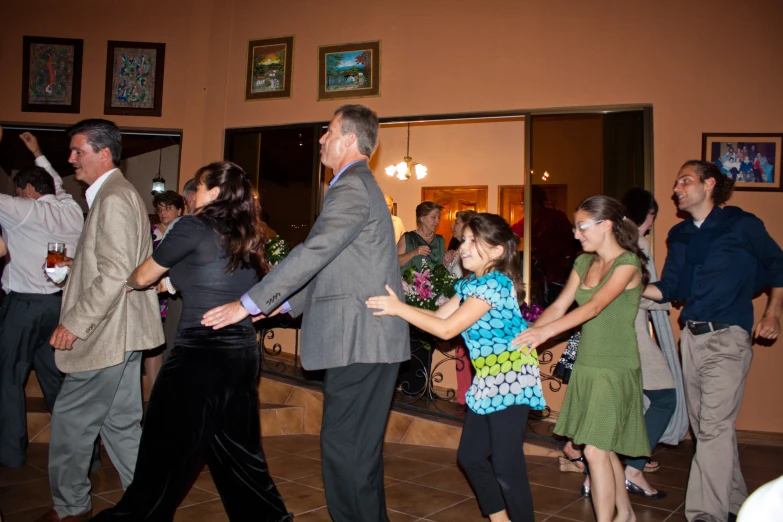 a couple dances with other people in fancy dress clothes