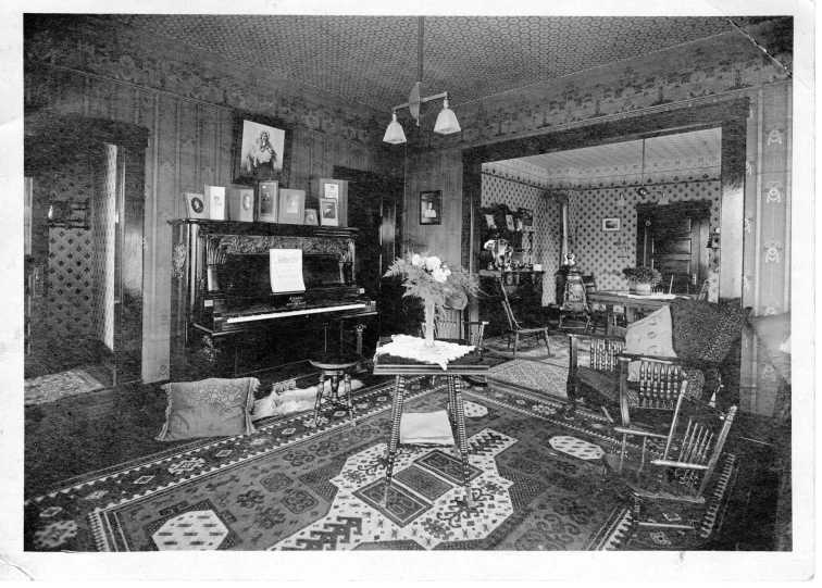 a living room with a piano and several chairs