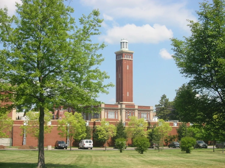 there is a tall clock tower in front of a large building