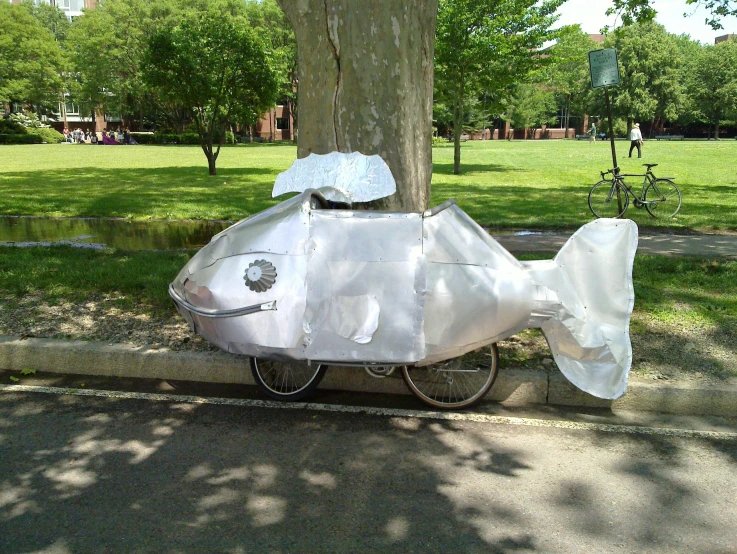 a fish sitting on the side of a street