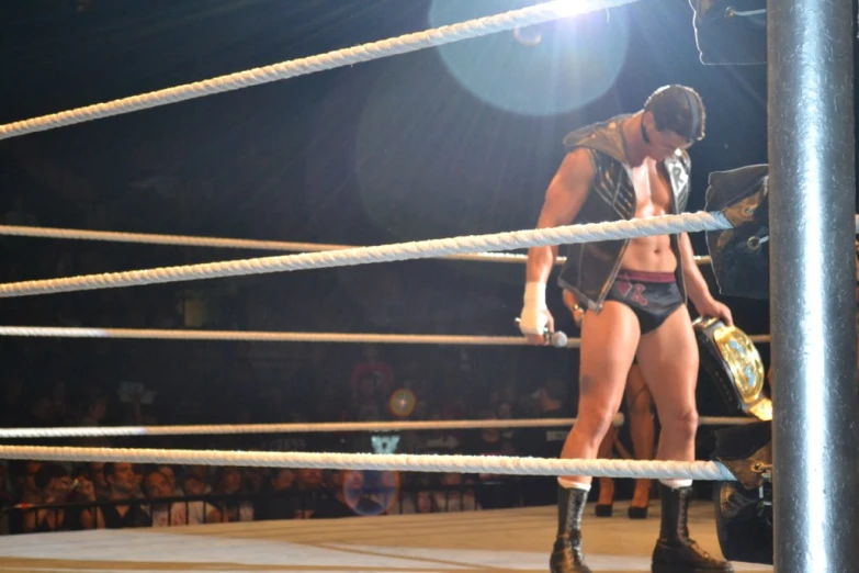 two women in wrestling gear hold their hands up