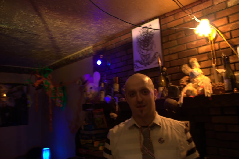 a bald man wearing a striped tie standing in a room