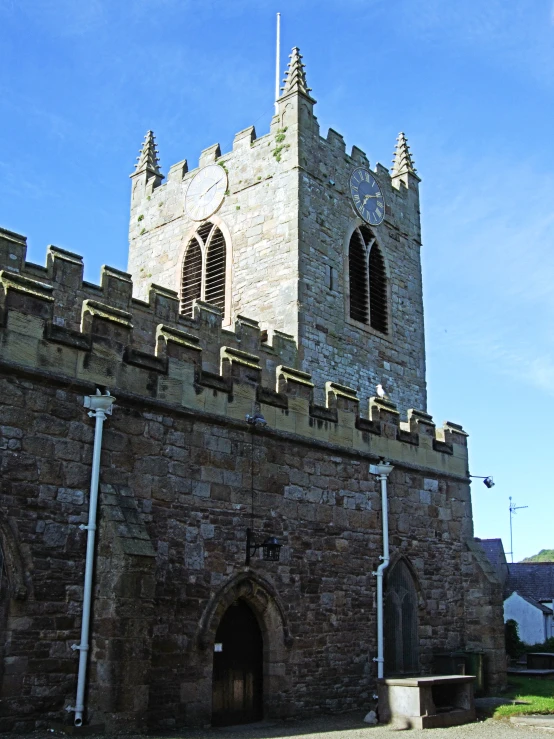 a large stone building with two towers, and a clock tower